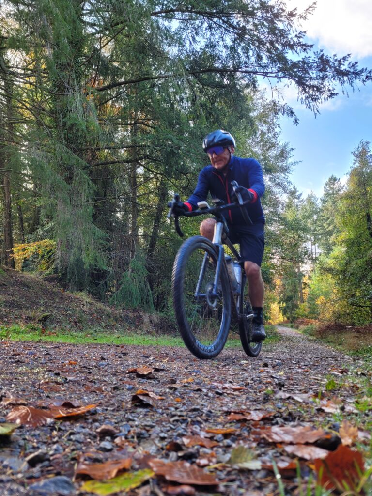 Dave ascending an Autumnal fire road in the Forest of Dean