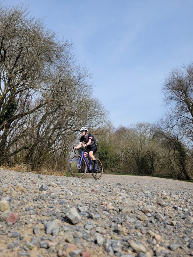 Nikki riding her gravel bike up to Llanwonno on a fire trail climb